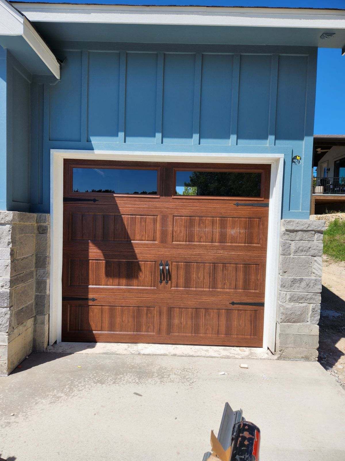 Woodtone garage door installation at a residential property in the Northforge Garage Collective service area