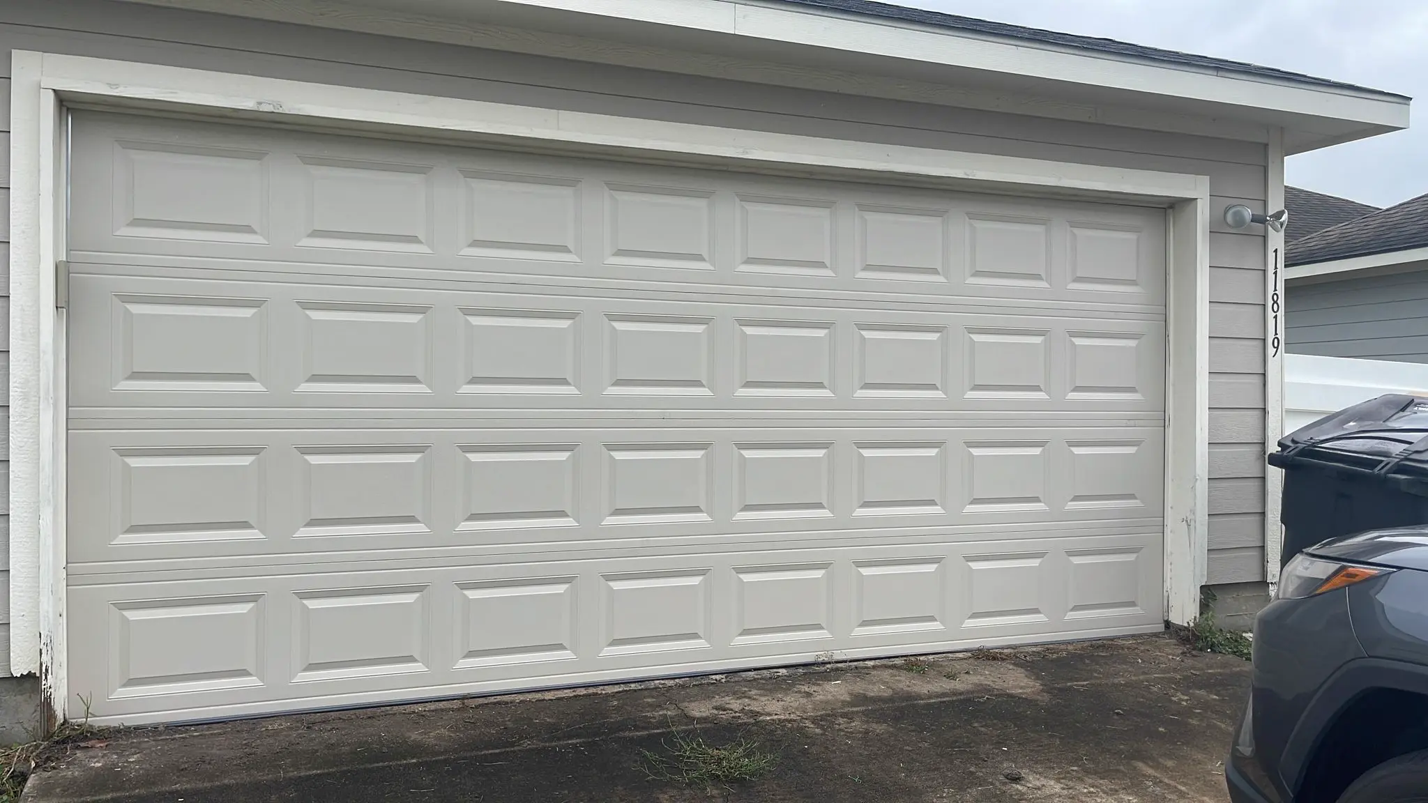 White double garage door replacement and finished exterior result